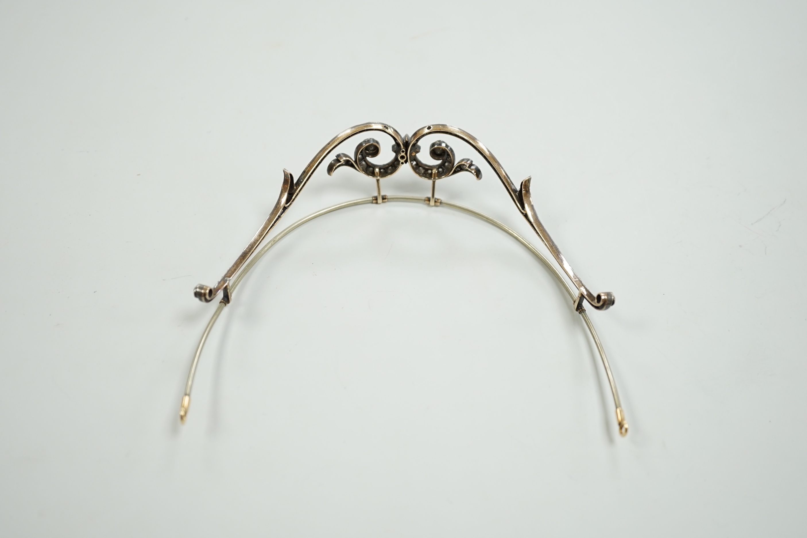 A 19th century, white and yellow metal paste cluster set tiara, width 13cm, the central stone with rose cut diamond chip spacers.